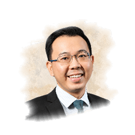 A man wearing glasses and a suit. Description generated by AI