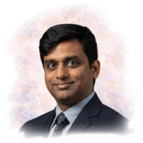 A man wearing a blue shirt and a blue suit. Description generated by AI
